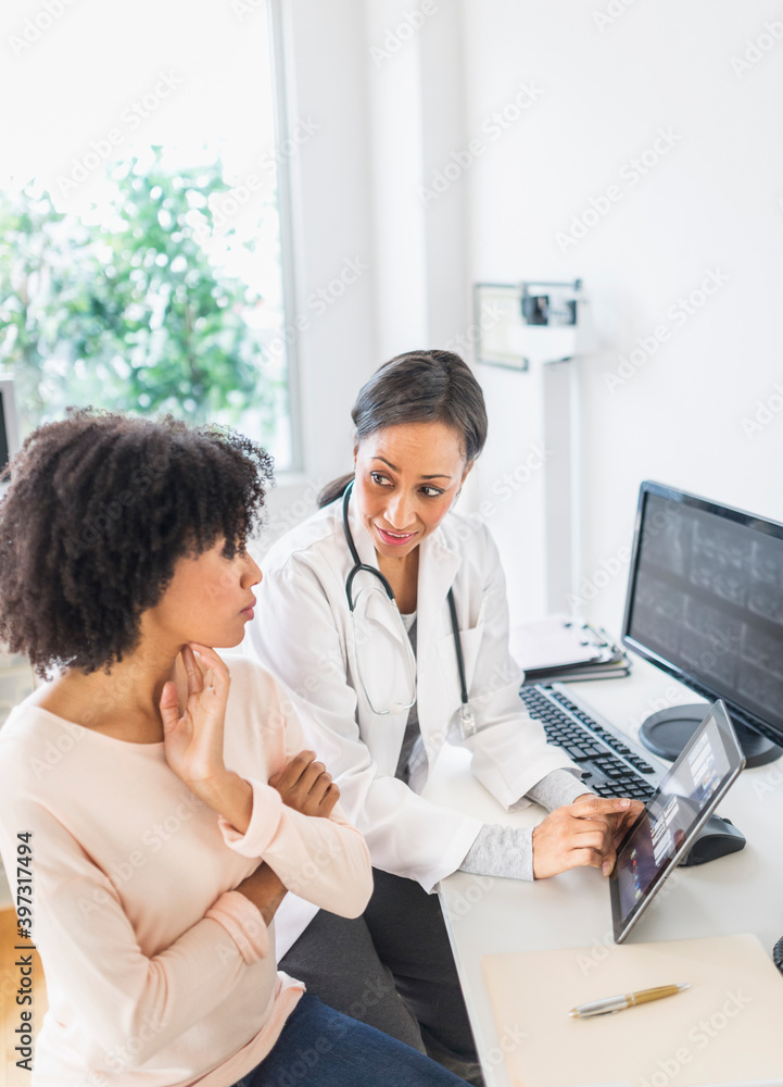 African American doctor and patient talking in office African American doctor and patient talking in office