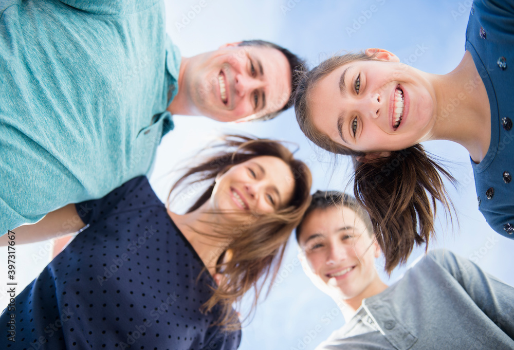 Portrait of smiling Caucasian family in huddle Portrait of smiling Caucasian family in huddle