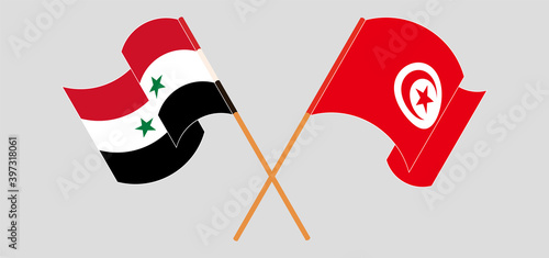 Crossed and waving flags of Syria and Tunisia