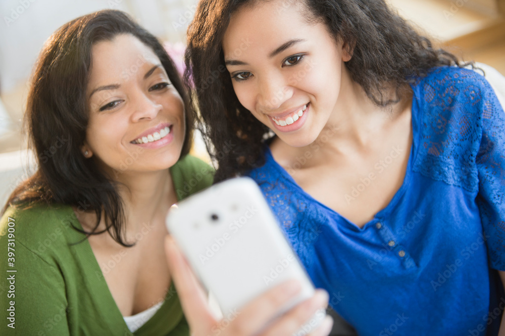 Mother and daughter taking picture with cell phone Mother and daughter taking picture with cell phone