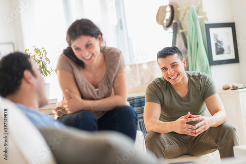 Hispanic friends talking in living room