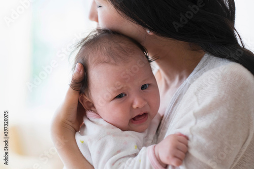 Asian mother comforting crying baby