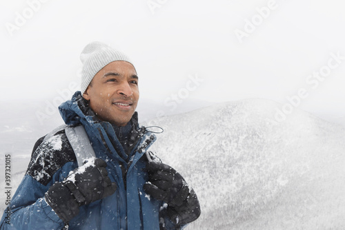 Black man hiking in snow