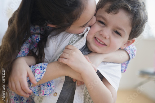 Close up of Caucasian girl kissing brother