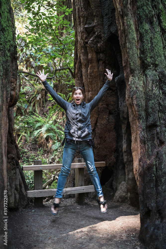 Caucasian woman jumping for joy in forest Caucasian woman jumping for joy in forest