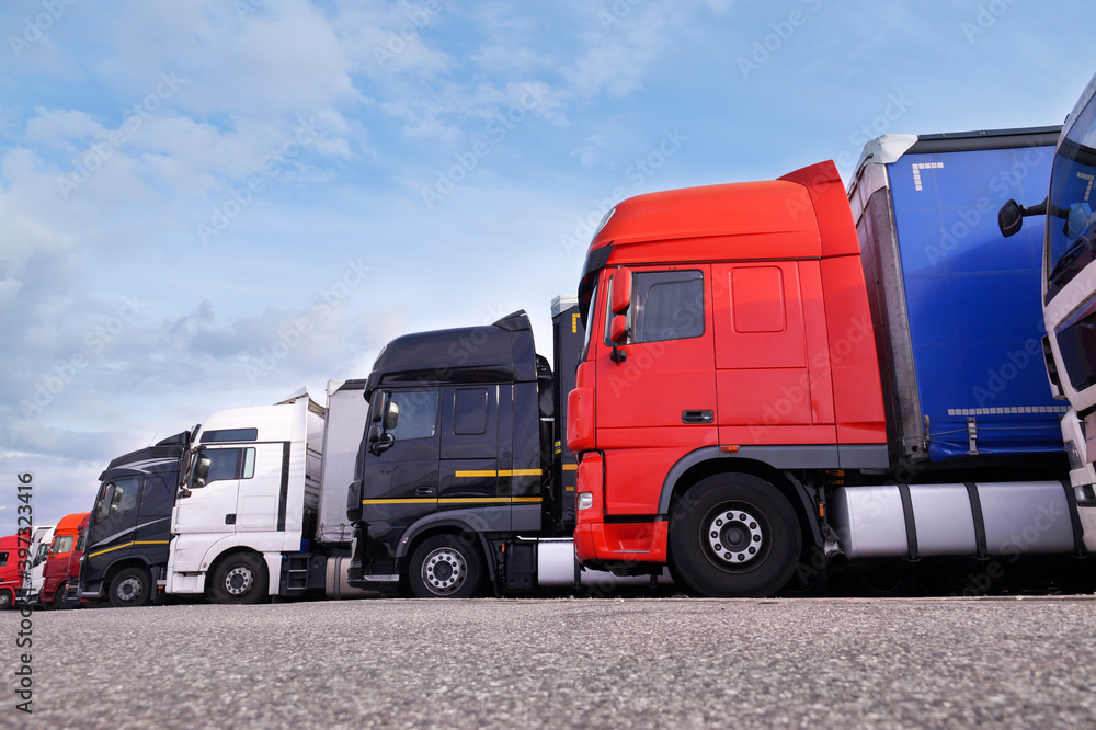 A row of trucks in a parking lot. Impact of a pandemic on transport lockdown. A row of trucks in a parking lot. Impact of a pandemic on transport lockdown.