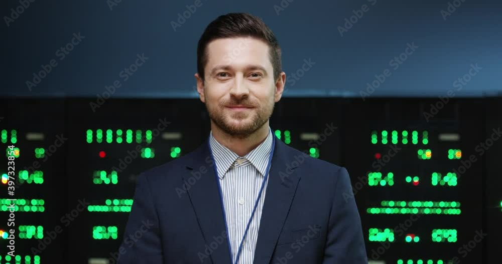 Close up portrait of Caucasian handsome happy male system administrator putting off medical mask standing in datacenter and looking at camera. Young joyful man in data storage. Server concept Close up portrait of Caucasian handsome happy male system administrator putting off medical mask standing in datacenter and looking at camera. Young joyful man in data storage. Server concept