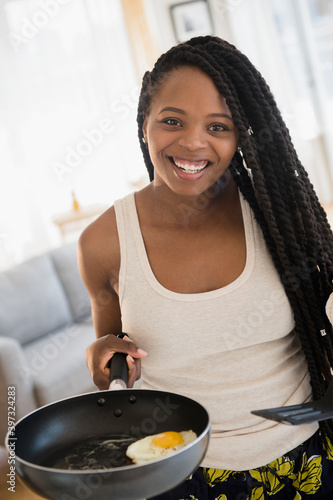 Black woman cooking egg photo