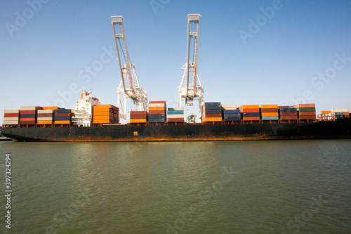 Cranes and shipping containers on barge photo