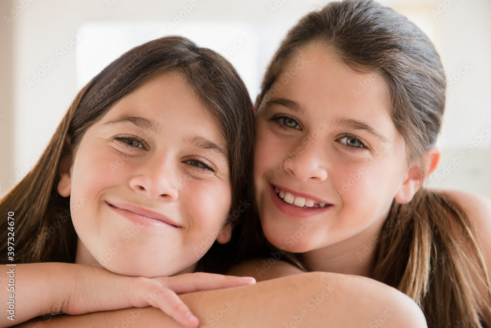 Caucasian twin sisters smiling Caucasian twin sisters smiling