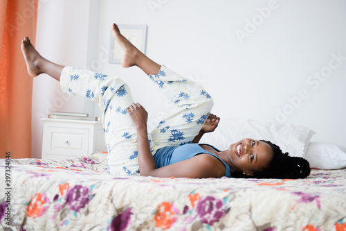 Black woman playing on bed photo