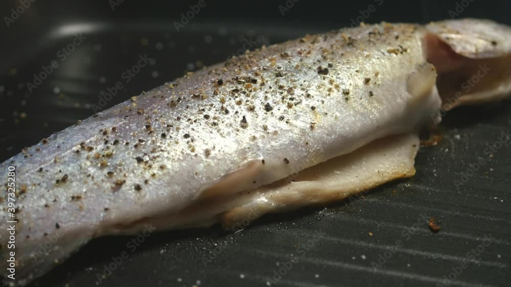 Cooking rainbow trout on frying grill pan Cooking rainbow trout on frying grill pan