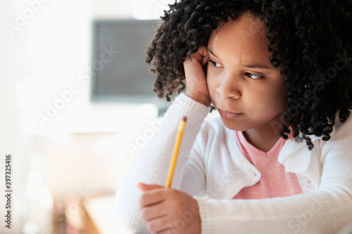 African American student writing in classroom photo