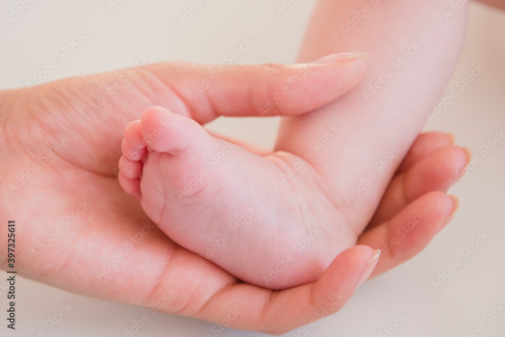 Close up of mother holding bare foot of baby Close up of mother holding bare foot of baby