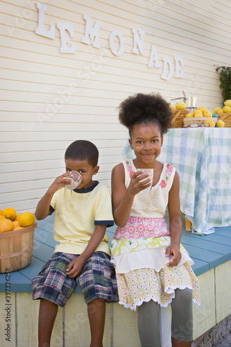 Mixed race brother and sister drinking lemonade photo