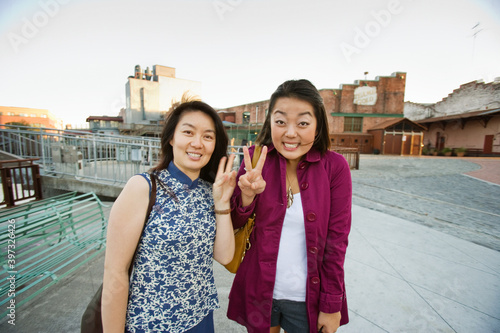 Chinese mother and daughter making peace sign photo