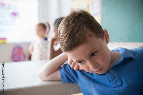 Sad student leaning on desk