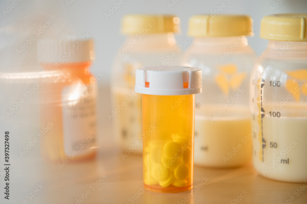 Bottle of prescription pills and bottles of breast milk Bottle of prescription pills and bottles of breast milk