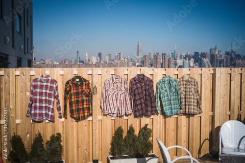 Flannel shirts hanging to dry in urban backyard, New York, New York, United States photo