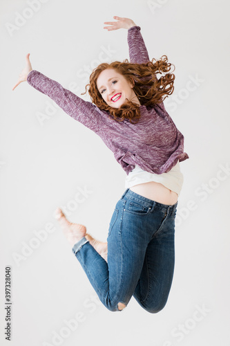 Caucasian woman jumping for joy