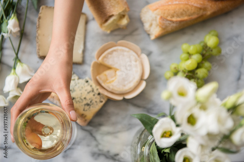 Hispanic woman drinking wine with cheese photo