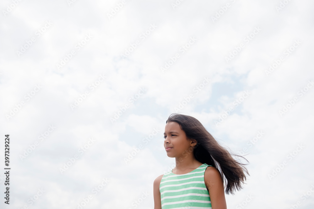 Wind blowing hair of serious Mixed Race girl Wind blowing hair of serious Mixed Race girl