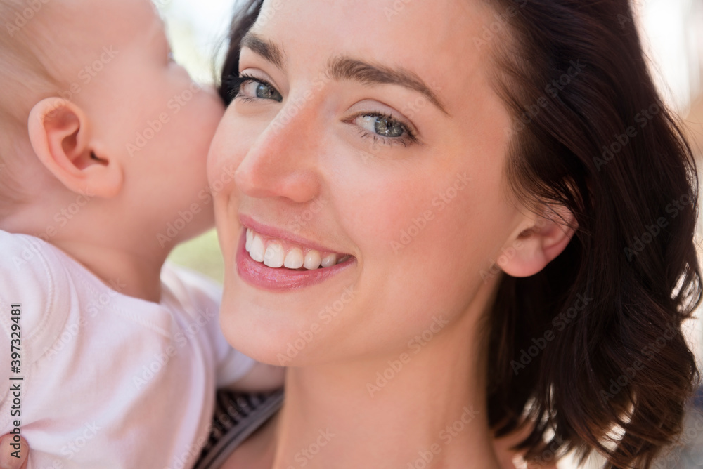 Caucasian mother holding baby son cheek to cheek Caucasian mother holding baby son cheek to cheek