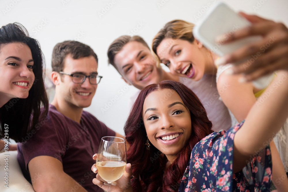 Smiling friends posing for cell phone selfie Smiling friends posing for cell phone selfie