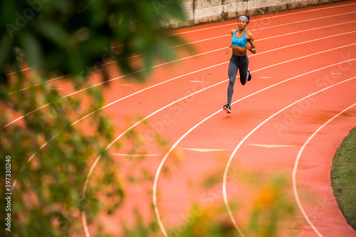 Black woman running on track photo