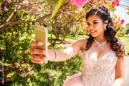 Hispanic girl posing for cell phone selfie