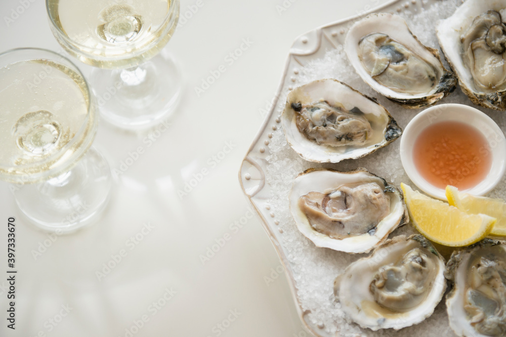 Studio shot of white wine and oysters Studio shot of white wine and oysters