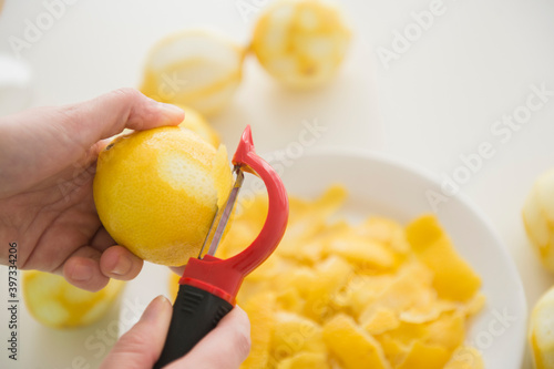 Personal point of view of person peeling lemons photo