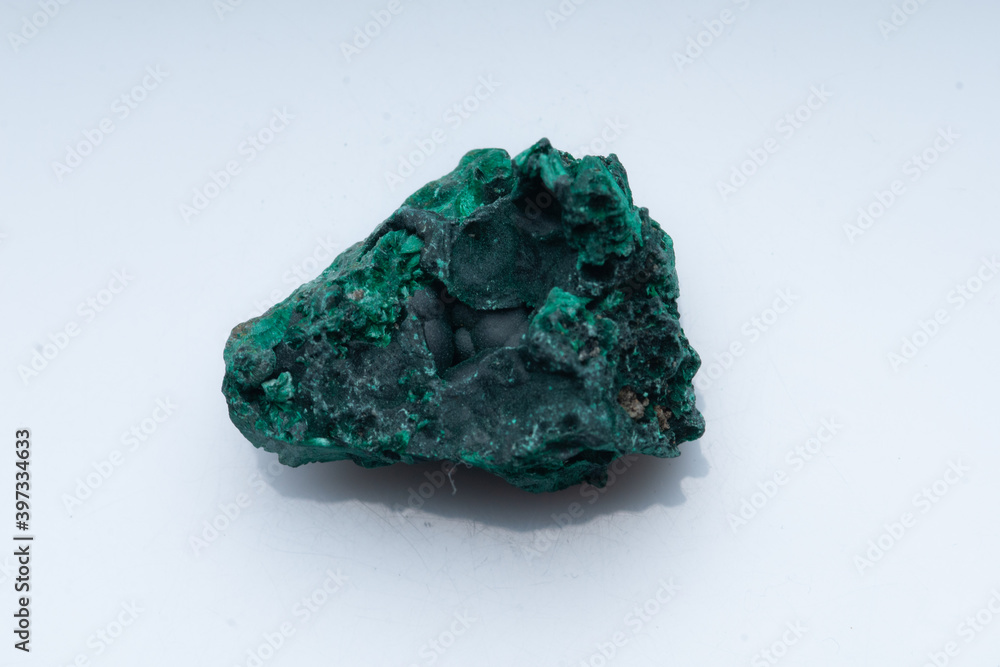 Malachite green ore on a white background. Natural green malachite Malachite green ore on a white background. Natural green malachite