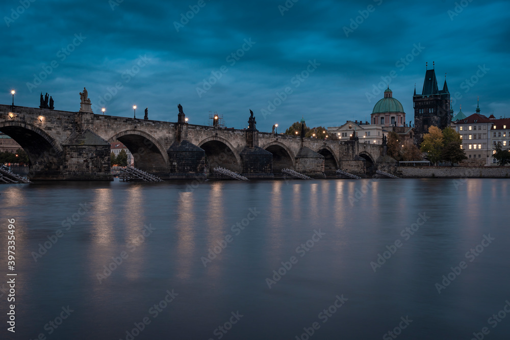 .Charles Bridge and the blurred Vltava river in the early evening of the Prague city center
