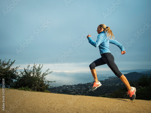 Woman running in mountains photo