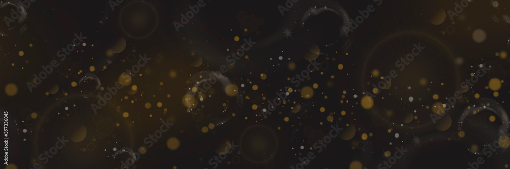 Obraz premium Yellow bokeh and lens flare on a dark background. Stars and spots. Defocused