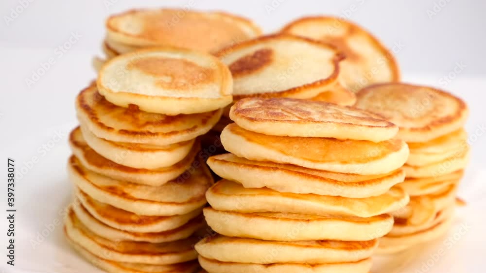 Pancakes. Rotating plate with Sweet pancakes served on table against white background Tasty breakfast food. Dessert rotating, Slow motion close up closeup Pancakes. Rotating plate with Sweet pancakes served on table against white background Tasty breakfast food. Dessert rotating, Slow motion close up closeup