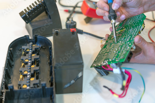 Service repair of an uninterruptible power supply for office equipment.