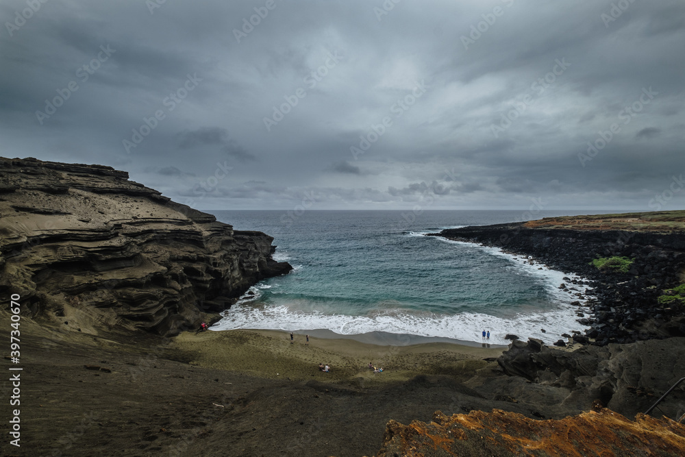 a beach with people walking on it