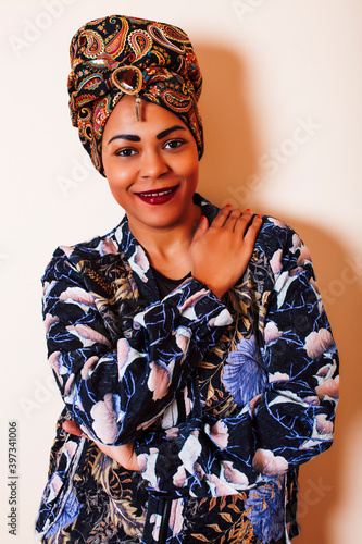 beauty bright african woman with creative make up, shawl on head like cubian closeup smiling photo