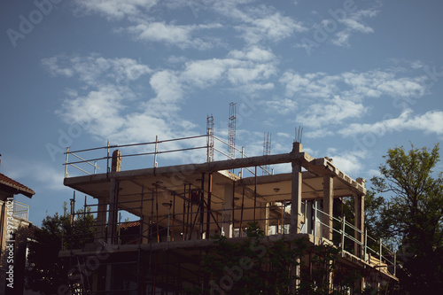 building under construction with partly cloudy sky © Alex