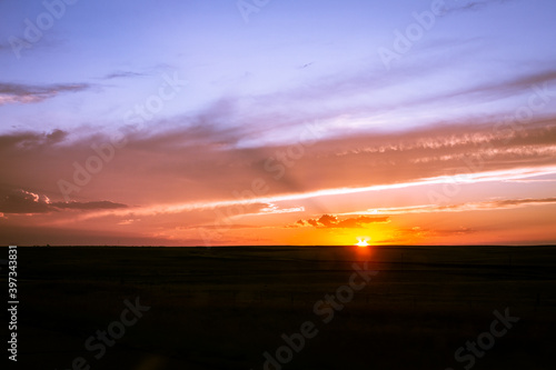 Panorama shot of colorful orange sunset behind the horizon in the middle america