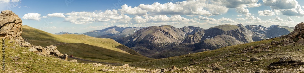 Panorama shot of green rocky hills with remnants of snow in Rocky mountains national park in america