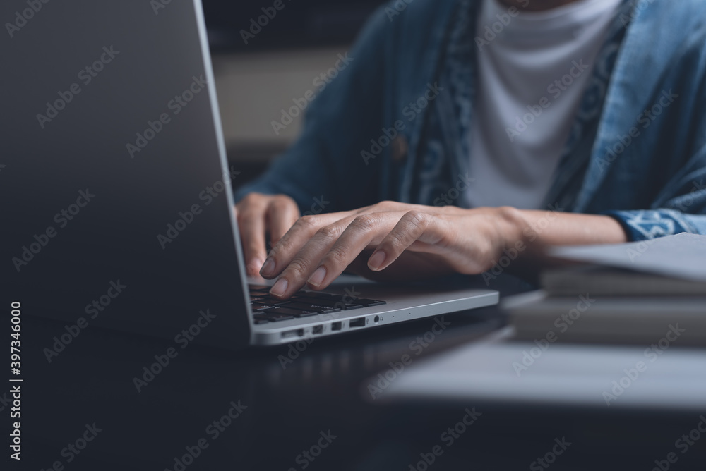 Woman online working on laptop computer at night from home office Woman online working on laptop computer at night from home office