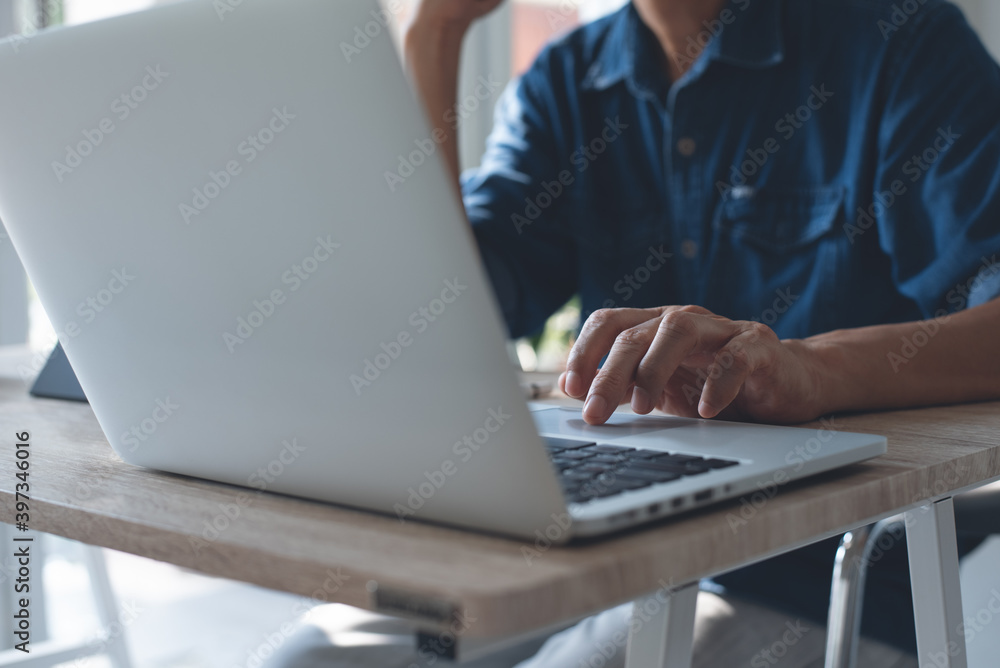 Business man online working on laptop computer surfing the internet from home office Business man online working on laptop computer surfing the internet from home office