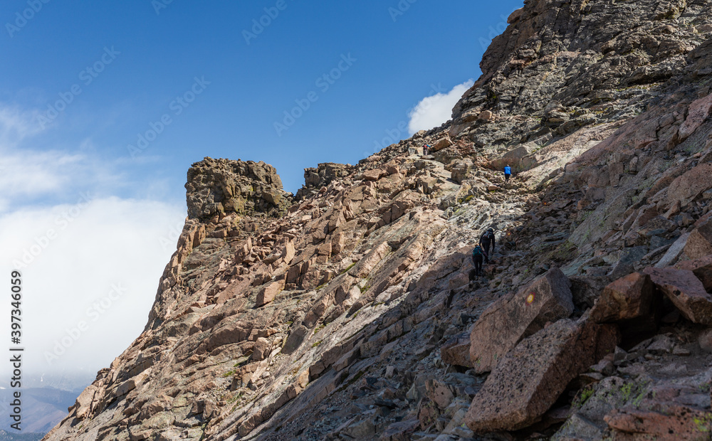 Wide shot  of climbers climb in part of trail to top of Longs peak in rocky mountains national park in america