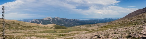 Panorama shot of green rocky hills with remnants of snow in Rocky mountains national park in america © AllThings