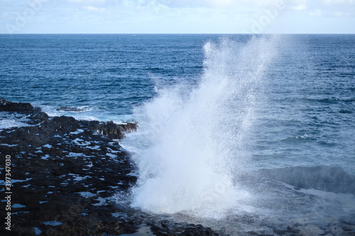 a rocky beach with waves crashing against it