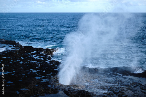 a large wave crashing into rocks