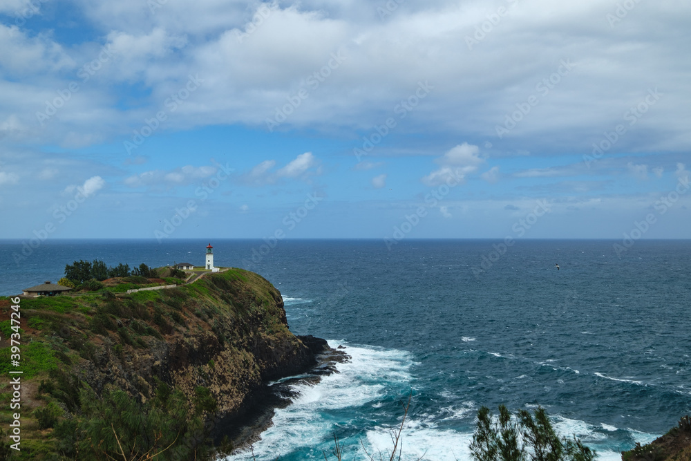 a lighthouse on a cliff above the ocean a lighthouse on a cliff above the ocean